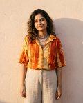 Woman wearing The Sunset Shibori, ochre and orange shibori dye